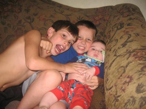 Three men that have stolen my heart! -  My grandson David in the middle of a bearhug by his Uncles my sons Willis and Phil. They hold the key to my heart!