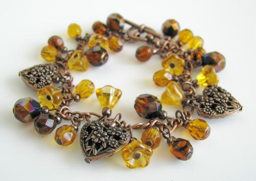 Blissful Autumn Bracelet - A 7 1/2' antiqued copper bracelet is adorned with three filigree hearts, amber bellflower czech glass beads, and a gorgeous assortment of deep brown and amber faceted glass beads. This blissful autumn bracelet is finished with a toggle clasp.  Available in my Etsy.com shop