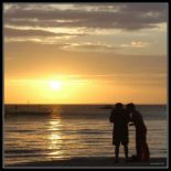 Lovers in the Sunset - I always think that spending time with your loveone watching the sun go down is always the best romantic time.   This is simply an image of two lovers spending time together watching the sunset in the beach