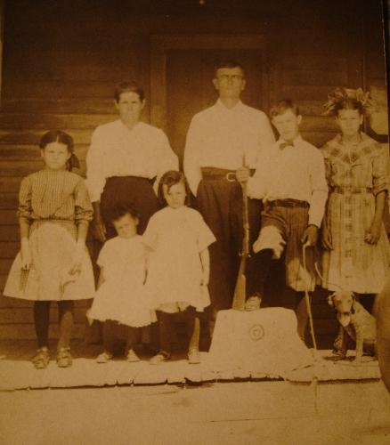 The George Washington Smith Family - Denton County, Texas, circa 1910. Parents, GW Smith b. 1856, his wife, Dixie Davis Evans Smith b. 1866. Son, Joe Bailey b. 1896, and daughters Zelma b. 1904, Ruby, b. 1908, Charlie, b. 1906 and Cora b. 1899. Not in the photo are children, James b. 1885, Minnie b. 1888 and Andrew b. 1890. The names of the dog and the horses' rear-end are unknown.