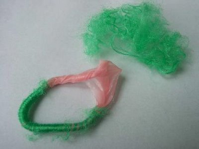 Condom hair bands - dangerous - This is a cut open hair band that has material wrapped around old condoms.