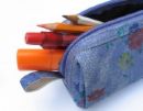 Pencil case - A pencil case or pencil box is a container used to carry pencils. A pencil case can also contain a variety of other stationery such as a pencil sharpener, pens, erasers, a stapler, and a calculator.  Pencil cases are usually made of either hard or soft plastic. Soft versions are typically fastened with a zipper. Decorated versions are popular with schoolchildren, a notable example being Hello Kitty pencil cases. Guidelines during examinations for students require for pencil cases to be clear/transparent, to prevent the hiding of cheat notes within.  Pencil boxes are usually made of hard plastic or wood, while the term pencil case is broader and often refers to a container made of soft material such as fabric, leather or soft plastic.