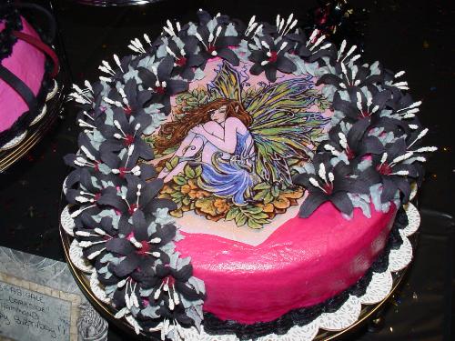 Goth Fairy Cake - This cake was done for my granddaughters 12th birthday. The fairy is an edible image and the black lillies are royal icing. All that black food dye was no fun!