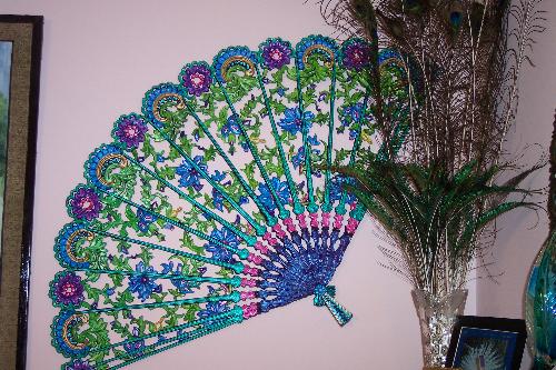 Hand Painted Peacock Fan - This is a large vintage Burwood fan that I bought at an auction. Burwood only made their home decor items in one color, brown. How dull is that. As soon as I saw the fan come up for auction, all I could see was a Peacocks Feathers. I took the fan home and painted it myself to resemble the feathers of a peacock. I have since then searched, ordered, found and bought 20 or more of these same fans and am in the process of painting them. Of course, all I see is Peacock Feathers. Perhaps someone else can see other colors for it. 