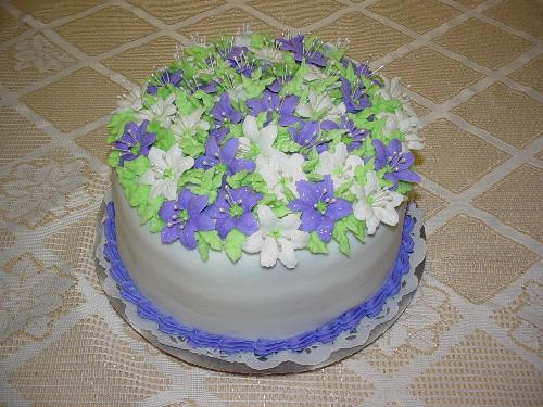 Birthday Cake - I did this cake for a friend's birthday. It was a white cake with buttercream icing and filling. There are about 3 dozen royal icing lillies on top. She was ecstatic when she saw the cake, so I guess I did a pretty good job.