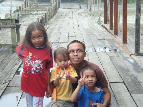 My Beloved Ones! - These are the pics taken sometime in August 2008 during our regular trip near the sea to get our fresh fish supplies.   The one in the pics will be my Husband, Ahmad, daughter, Fatin, and sons Adam and Hakim. Adam is the bigger one!