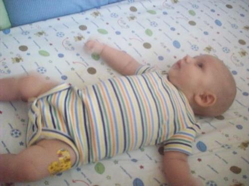 Bryan after getting his 2 month Vaccs - He took it like a man! this is after we got home. he had cried for a sec when the doc gave it to him, then i held him and he was ok :)
