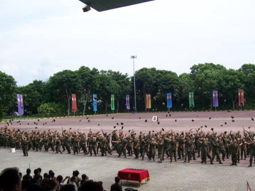 Singapore Armed Forces Basic Military Training Cen - SAF soldiers throwing jockey caps in their PO parade at Puala Tekong. The new privates, having completed their 3 months of grueling BMT, will enter their next stage of National Service (NS) upon receiving their posting orders. Every able-bodied man must undertake NS for a minimum of 2 years upon reaching 18 years of age.