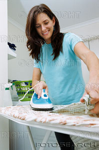Women Ironing Cloths - She sure looks happy to be ironing. I never looked that happy whenever I had to iron cloths years ago. I am happy that I don't have to do that chore any longer. Thank goodness for small blessings.