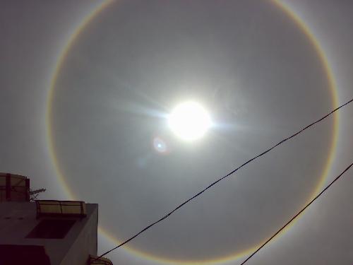 Natural Phenomenon - Today, I see unusual sunlight shine in my place. There is a large circle around the sun. I hear that it's call 'Halo'  Now, the sun is still shine like this. Are you place, the sun shine like this too ?