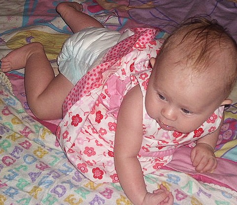 Crawling daughter - Crawling baby in a pink dress.
