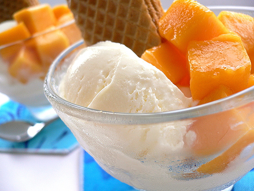 Ice cream and mango -  It is a great combination for delicious dessert. A vanilla ice cream with mango cut in into cubes and have wafer.