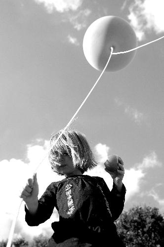 Molly (age 5) - My daughter (Molly) eating a tomato and holding a weather balloon. This could well be the best photo ive taken. I was pleased with the angle, thought it looked nice in b&w too.