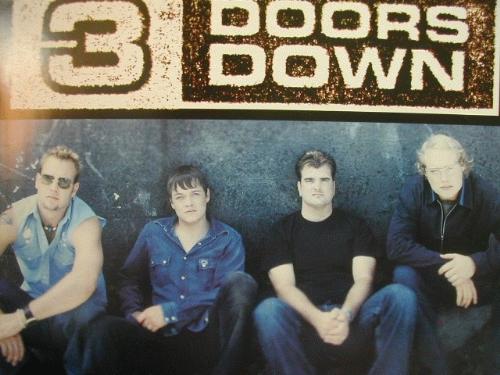 Three Doors Down - Members of the band Three Doors Down sitting underneath their band name.