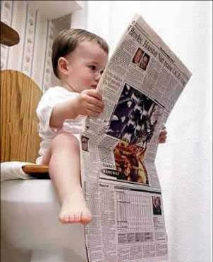 pictures1 - A children is reading the newspaper very absorbedly