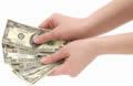 Cash in hand -  This is a picture of some cash in hand.