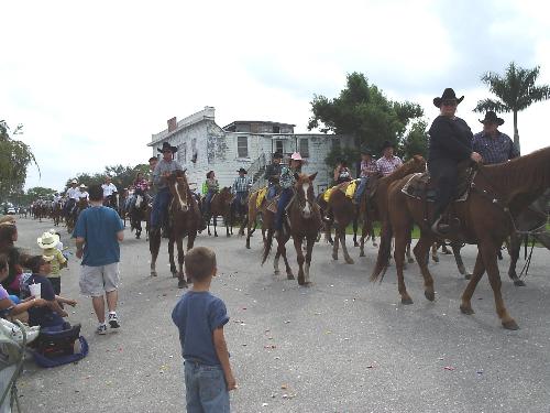 The other side of Florida - This is my little piece of small town America in south central Florida. The cowboys are real cowboys. The cowgirl in the pink hat is a relative with her daddy riding next to her.