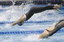 swimming / diving - a person diving into the pool, and the picture is paused just as the person is about to enter the water.