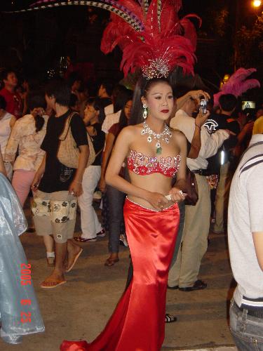 Ladyboy or boylady?  - When I took this picture to be as a memory that I have ever been to Pattaya, Tailand, "she" was looking forward to a group photo being taken with the tourist so as to earn some money. I felt sad with "her". 