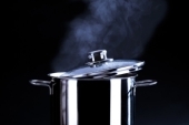 pot with steam - Big, stainless pot, cooking with steam coming out.