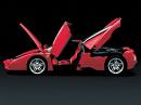 driving - an expencive red car been shown with all its doors open with a black background.