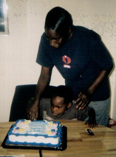 Helping Cut The Cake - This is me and my son on his 5th birthday, I am helping him cut the cake.