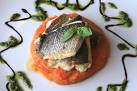 seafood - fish on a plater with herbs and sauces on a plate.