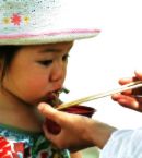 Child being fed - Child eating. Somebody is feeding the child.