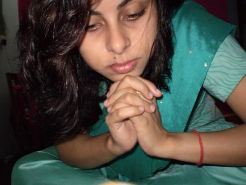beautiful woman praying ... - woman in green...