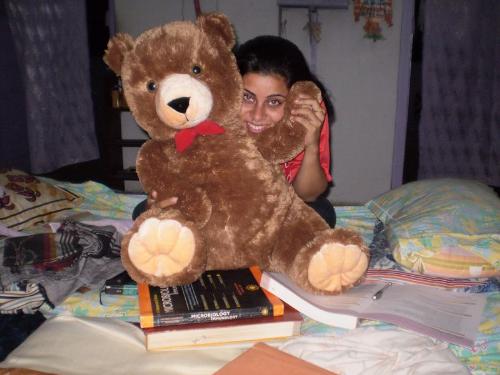 beautiful woman sitting.. - holding a teddy ....
