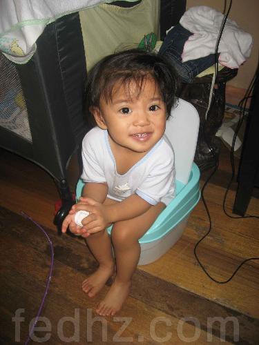 yz and potty train - this is my baby, yz sitting on her potty, waiting for her to pee. this potty is inside the room, the other one in the toilet