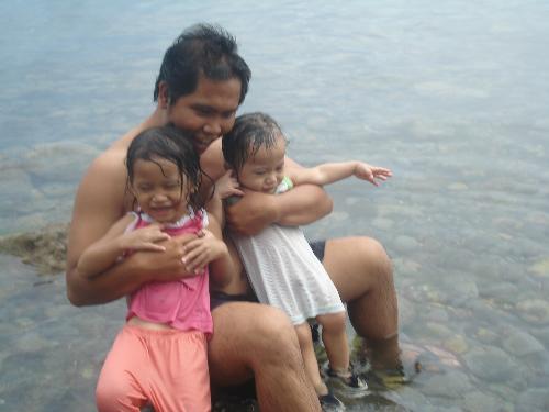 my husband with my kids - this shot was taken last sunday when we were at the beach and my kids were really having fun wit my husband playing with them....he is really a good father for my kids :))