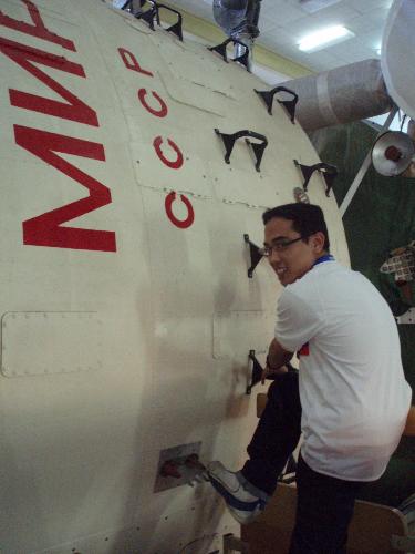i'm in space...haha - i was trying to climb 'mir' of USSR (soviet union) spaceship...called mir or known as 'the wolrd'...this picture was taken when i was in starcity tour in moscow,russia.