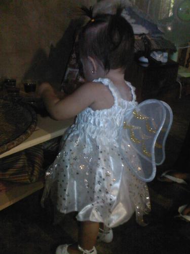 sophie's first birthday - sophie in her angel costume messing around with the gelatin