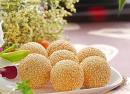 mayuan - we call this mayuan in china  it is made of power ,people put the small doughball in oil and it will turns into a ball taht's really bid relatively. then they will scatter some seasame on that . it is what we always eat as breakfast
