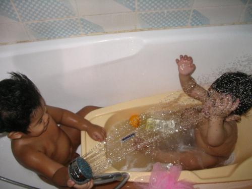 boys' bath time - This is my boys' shower time. It took me 15 minutes chasing them around and convincing them to take a bath. Eentually they got tired running and here they are, enjoying in the tub and bonding. Big brother Sam is trying to bath his little brother Leaf. They always have fun in the shower.