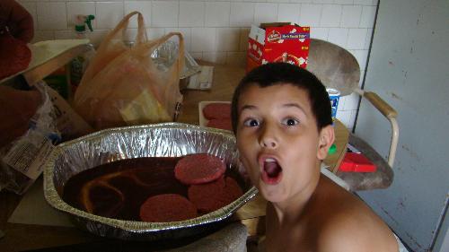 Birthday boy and a cook - The birthday boy helping prepare the burgers in teh marinade sauce.
