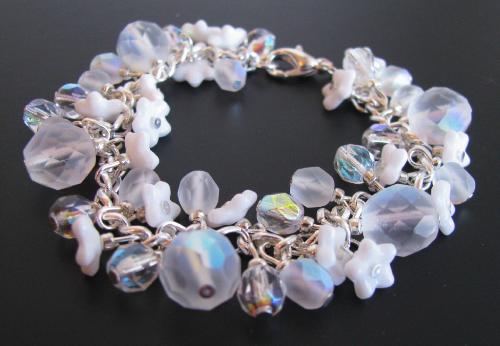 Snowflowers Bracelet - a 7 1/2' bracelet made with faceted Czech glass beads (matte finished clear & irridescent sheer icy crystal) Tiny opaque white flower cup beads accent the bracelet like tiny flowers poking through the first snowfall of winter. Available in my Etsy.com shop.