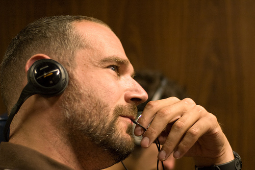 Conference listening - A middle-aged man listening to music while on a conference.