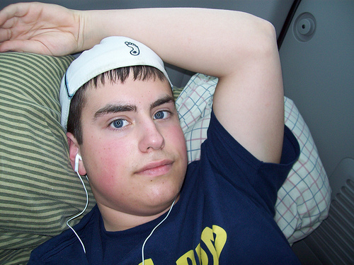 Teenager's Sound Trip - A teenager listening to music while relaxing inside a car.