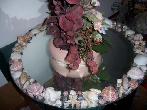 Centerpiece Mirror on Dining room table - I 'made' this! I decorated this round mirror with sea shells we found in Florida. It's on my mother's dining room table at her home on the oceanfront in Jacksonville Beach, Florida. I've done a lot of picture frames (I'll show you in a minute) the same way - they're for sale if...