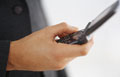 cell phone advantages - Close-up mid section of businessman holding mobile phone
