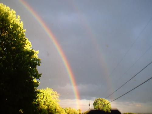 Touch the rainbow - I've never seen 3 overlapping rainbows before. Seeing two is rare enough, but it's amazing to see 3 at one shot and had to take this picture.  It's wonderful luck!!