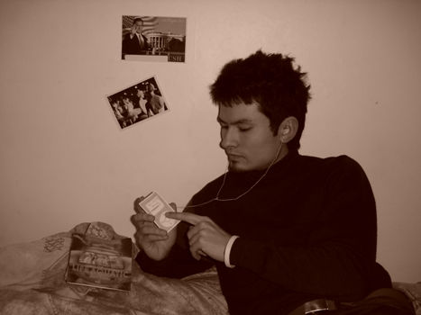 You gotta be kidding me!?! - A guy in a black sweatshirt listening to his... what's that, a paper Ipod?