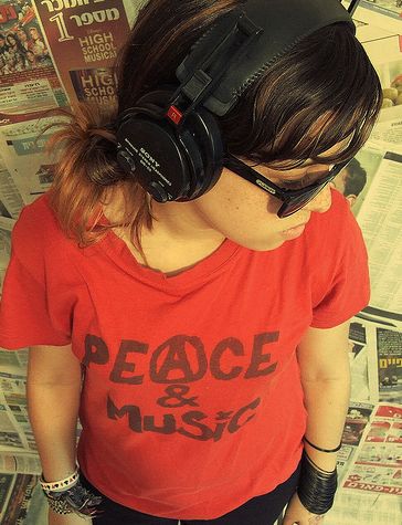 Peace and Music - A girl listening to music while spreading the message of peace.
