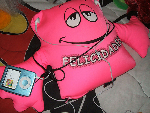 Felicidades - A stuff toy named Felicidades listening to music through an Ipod Nano.