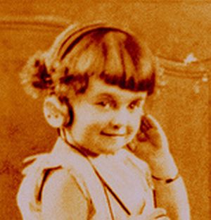 Talking About Cuteness - A cute little girl showing her adorable smile while listening to music.