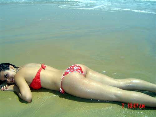 girl lying bums up on the beach - a sexy cute looking girl is lying down showing her big nice pair of bums in beautiful pink bikini on the beach