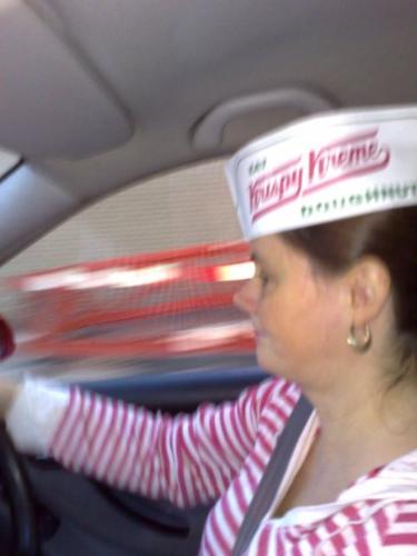 my sister wearing a krispy kremes hat - looking like shes got a new job cos her tshirt matches their branding and looks like it's a uniform