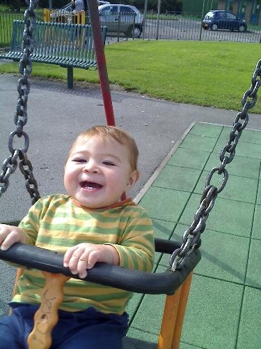 my baby - zach on the swing at the playground